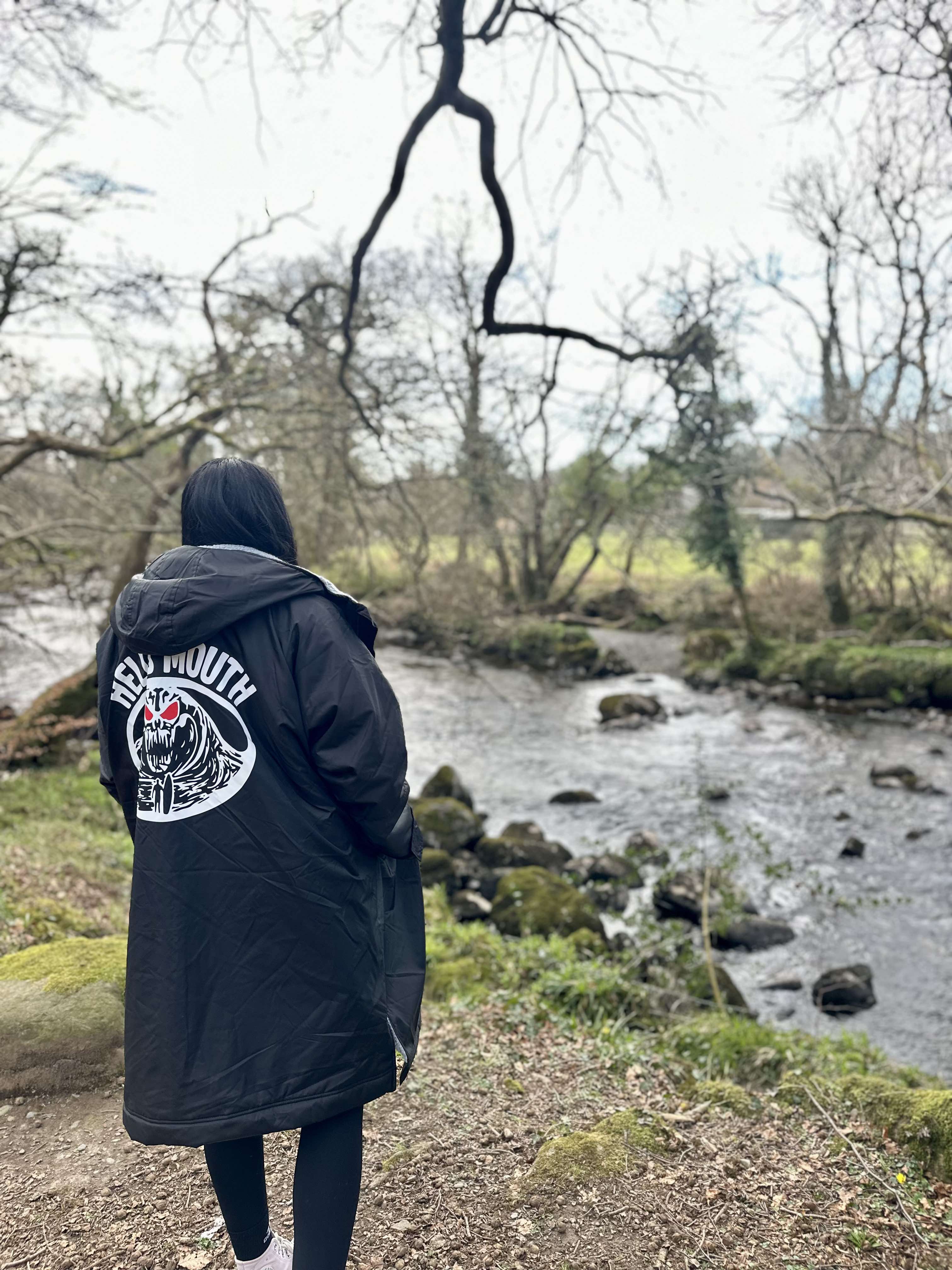 our iconic Hell's Mouth jumper featured on our model who is sat on the beach.